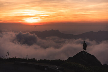silhouette of a person above the clouds - 425244095
