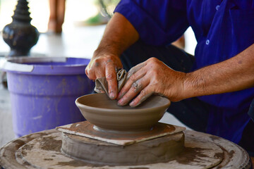 Fototapeta na wymiar Clay molding to make ancient pottery of the Sukhothai people, Thailand.
