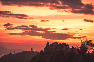 Mountain top sunset silhouettes - 425244436