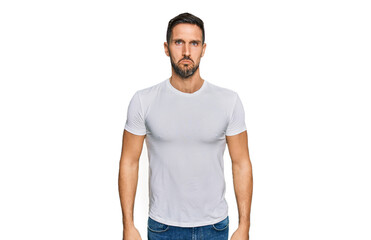 Handsome man with beard wearing casual white t shirt depressed and worry for distress, crying angry and afraid. sad expression.