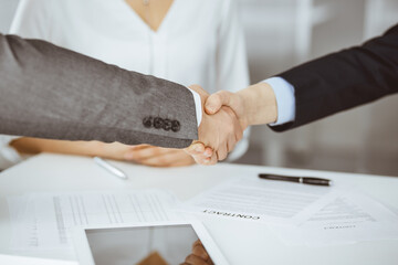 Business people shaking hands finishing contract signing, close-up. Business communication concept. Handshake and marketing