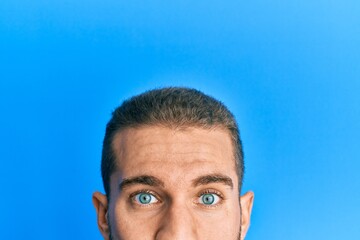 Young caucasian man showing head and half face looking at the camera blowing a kiss being lovely and sexy. love expression.