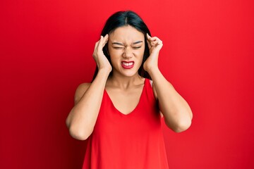 Young hispanic girl wearing casual style with sleeveless shirt suffering from headache desperate and stressed because pain and migraine. hands on head.