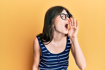 Fototapeta premium Young beautiful caucasian girl wearing casual clothes and glasses shouting and screaming loud to side with hand on mouth. communication concept.