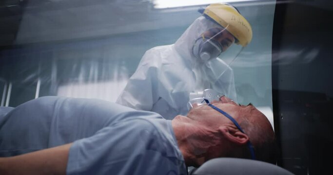 Senior man in respirator talking with doctor