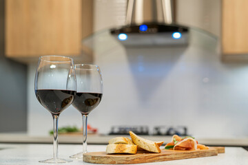 Glasses of wine and snacks served in the kitchen