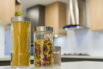 Fototapeta na wymiar Glass containers with noodles and vegetables in the kitchen