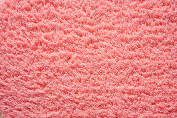 Top view of fluffy light pink or old rose color rug texture made from synthetic fabric show detail of fiber for background