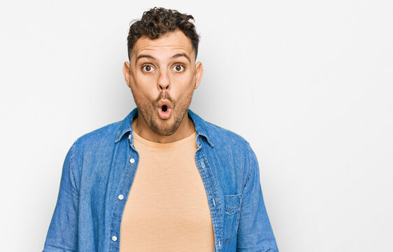 Young hispanic man wearing casual clothes scared and amazed with open mouth for surprise, disbelief face