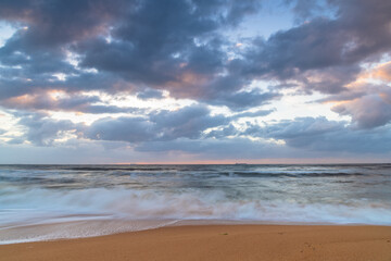 Fototapeta na wymiar Sunrise at the seaside with a cloudy sky