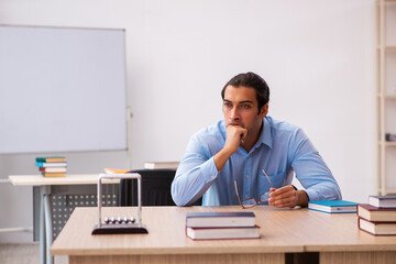 Young male teacher in the classroom