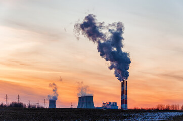thermal power plant and cooling towers near the city in winter