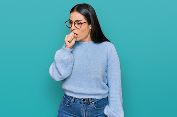 Young hispanic woman wearing casual clothes and glasses feeling unwell and coughing as symptom for...