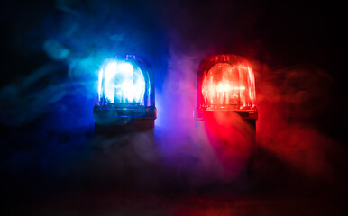 Fototapeta na wymiar Police car blue and red round vintage siren in dark. Rotating retro style police siren in dark.