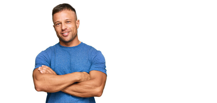 Handsome muscle man wearing casual clothes happy face smiling with crossed arms looking at the camera. positive person.