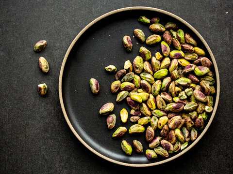 Raw Pistachios On A Plate. Green Nuts. Green Pistachios.