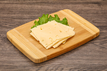 Sliced yellow cheese over board