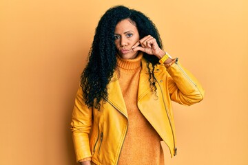 Middle age african american woman wearing wool winter sweater and leather jacket mouth and lips...
