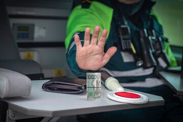 Street lighting. A special car inspector shows a hand gesture. On the table is a wallet and a red...