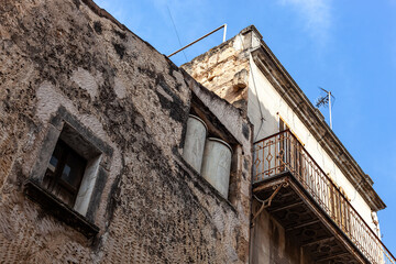 old house in the old town with dirty facade against the sky