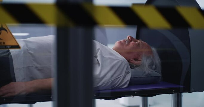Senior man in hyperbaric chamber reassuring doctors