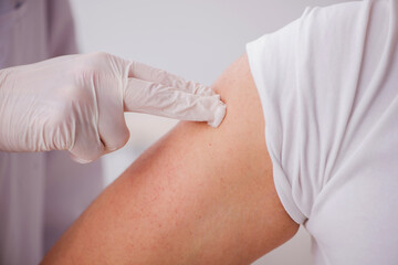 Young male patient visiting old male doctor in vaccination conce