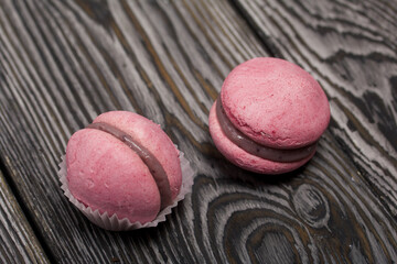 Lavender macaroni cake with white chocolate and blueberries. Lies on pine boards.