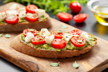 Bruschetta Appetizers with cherry tomatos pesto and mozzarella