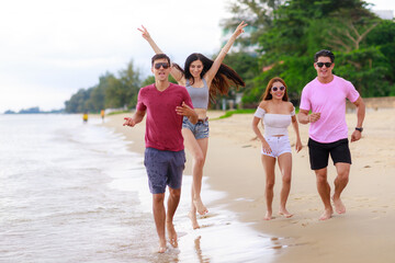 Group on teenager walking relax on the beach. Holiday and vacation concept.