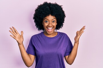 Young african american woman wearing casual clothes celebrating victory with happy smile and winner expression with raised hands