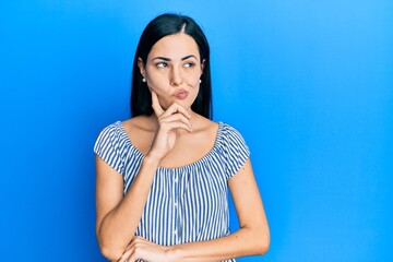 Beautiful young woman wearing casual clothes thinking concentrated about doubt with finger on chin and looking up wondering