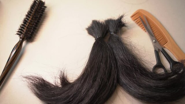 Placing locks of hair on a white table