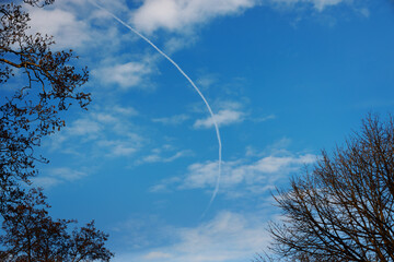 trail of airplane in blue sky
