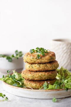 Green broccoli and quinoa burgers served with lettuce and microgreens. Healthy vegan food concept. vertical image, copy space