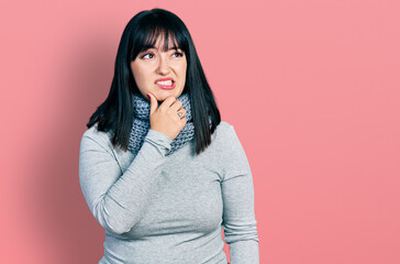 Fototapeta premium Young hispanic plus size woman wearing winter scarf thinking worried about a question, concerned and nervous with hand on chin