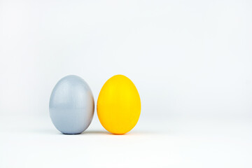 Yellow and gray easter egg isolated on white background. Chicken eggs  stands on surface, close up. Object for design to easter holiday