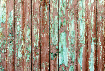 old wood planks with peeling red paint
