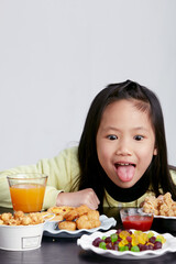 Cute Asian little girl eating happily