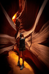 A young girl admiring the beauty of the Upper Antelope Canyon in the town of Page, Arizona. United States.