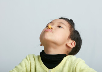 Cute Asian little girl eating happily