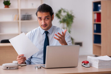 Young male employee working in the office