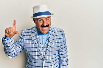 Mature middle east man with mustache wearing vintage and elegant fashion style smiling with an idea or question pointing finger up with happy face, number one