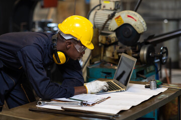 Manufacturing Factory black male Mechanical Engineer Works on Personal Computer at Metal lathe...