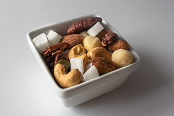 Dried nuts. Pieces of coconut. A healthy snack. Tasty food. Healthy eating. Cashews, almonds and hazelnuts. A mixture of nuts and fruits. Vitamins in food. Nutritious breakfast. Natural ingredients. H