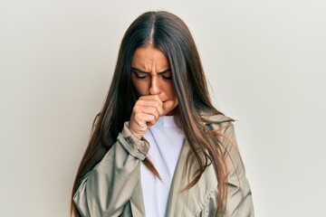 Beautiful hispanic woman wearing casual clothes feeling unwell and coughing as symptom for cold or bronchitis. health care concept.