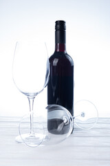 Glasses of wine, bottle of wine and board with cheese