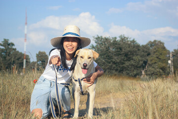 Dog lover and cute labrador travel in nature with copy space on sky