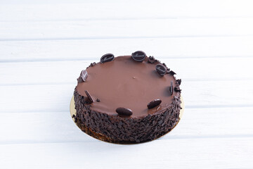 Chocolate cake on a tray and on a wooden background