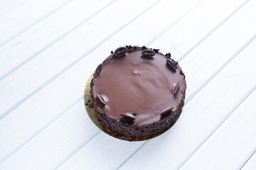 Chocolate cake on a tray and on a wooden background