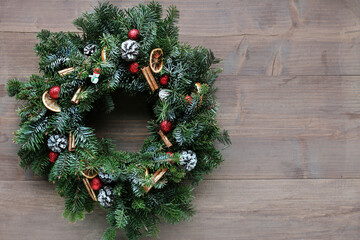 Fototapeta na wymiar Big traditional Christmas wreath on wooden background